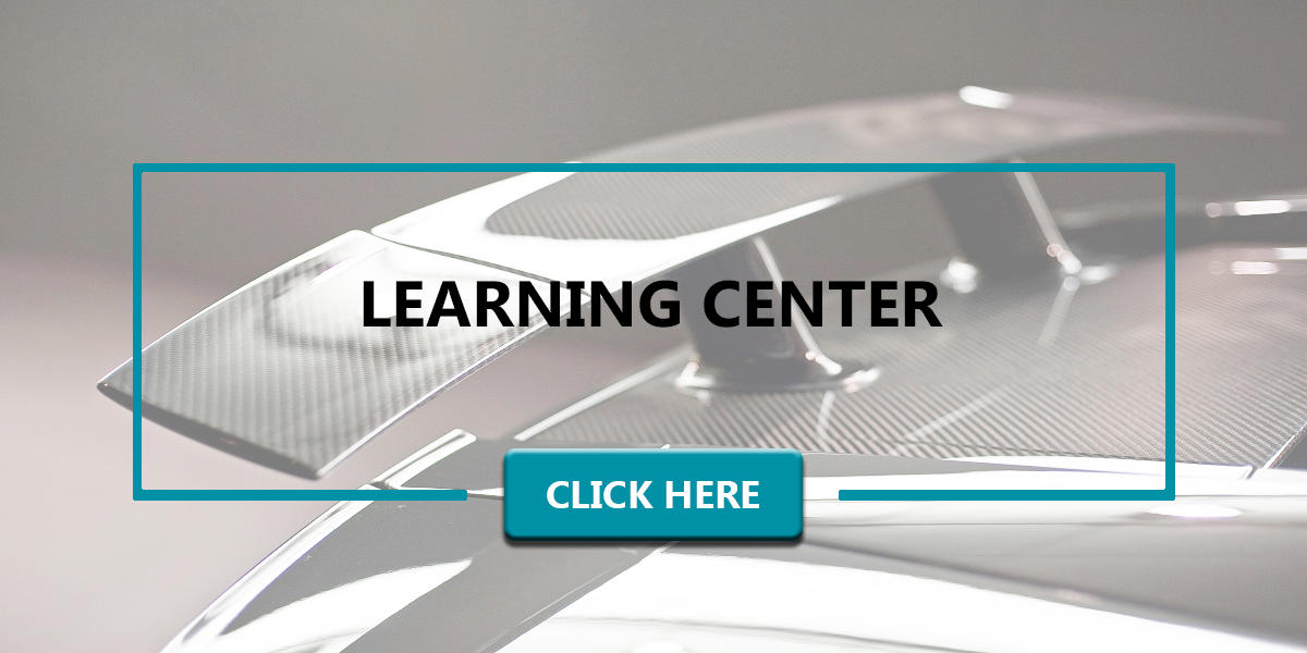 Carbon fiber fin on the back of car in the background. In the foreground is the words 