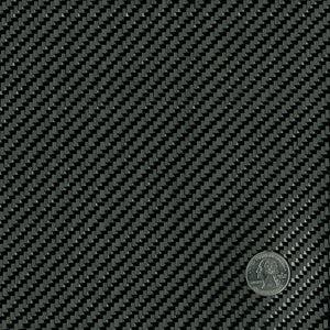 Close up of black twill weave carbon fiber fabric with quarter in the corner for weave size reference.