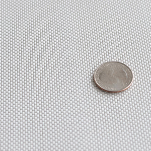 Six ounce fiberglass cloth laid flat with quarter on top to show plain weave size reference. 60 inch width.